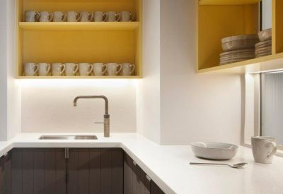 Compact modern kitchen featuring dark wood cabinetry and bright yellow open shelving.