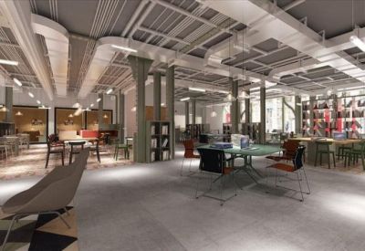 Large open-plan workspace with industrial ceilings and modern office furniture.