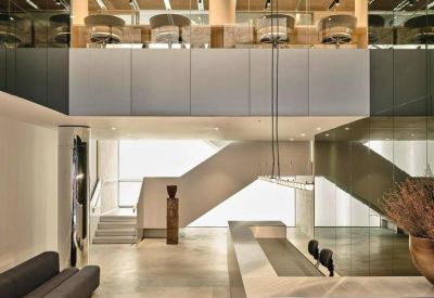 Modern lobby at Borough Yards, 13 Dirty Lane with sleek reception desk and architectural staircase.