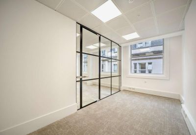 Modern workspace featuring a black-framed glass partition wall.