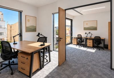 Spacious two-desk private office with natural light and scenic window views.