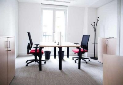 Symmetrical two-person office suite with red-seated chairs and large windows.