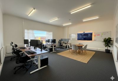 Private office with two desks, chairs, and a window.