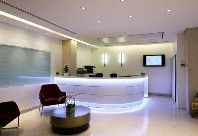Sleek modern reception area with curved desk and integrated lighting.