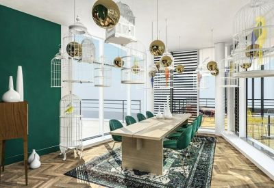 Elegant meeting room with a long wooden table, green velvet chairs, and decorative birdcages.
