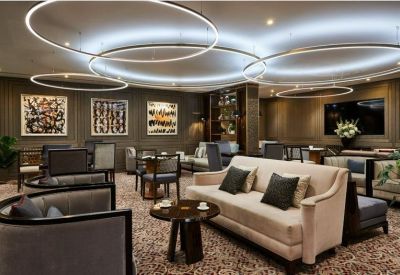 Spacious communal lounge with modern circular light fixtures and plush seating.