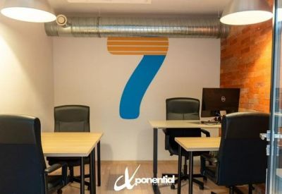 Private office room with desks and a large number 7 graphic on the wall.
