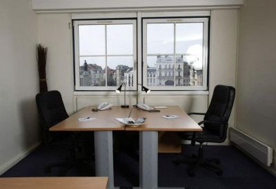 Private two-person office suite with natural light from two large windows.