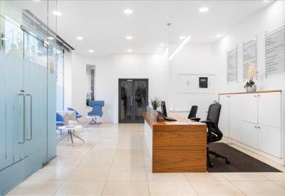 Professional reception area featuring a wood-fronted desk and polished floors.