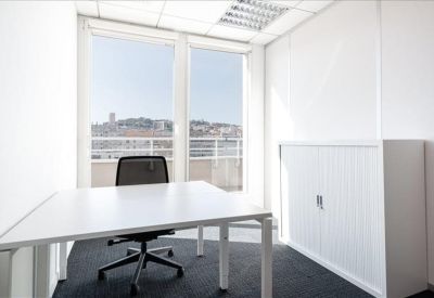 Private office featuring a white desk and a large window with city views.