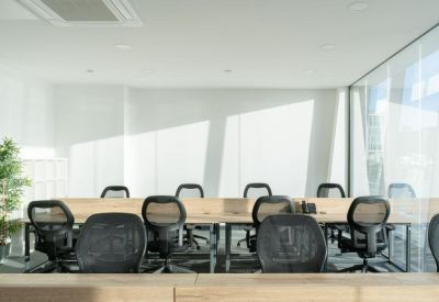 Sleek open-plan workspace with multiple rows of desks and ergonomic chairs.