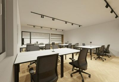 Large open-plan workspace with white desks and black track lighting.