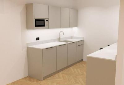 Sleek minimalist kitchenette with grey cabinetry and integrated microwave.
