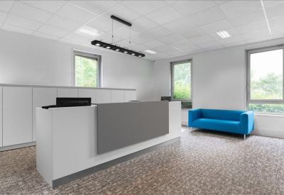 Bright reception area featuring a white and grey desk and a vibrant blue sofa.