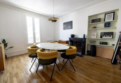 Bright conference room with a marble table, fireplace, and built-in shelving.