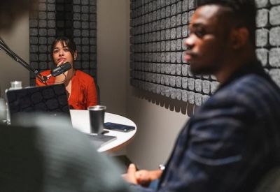 Professional podcast studio or meeting room with soundproofing wall panels and a microphone.