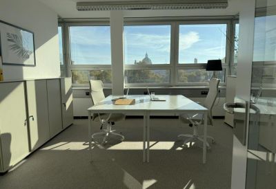 Private two-person office suite with white desks and bright natural light.