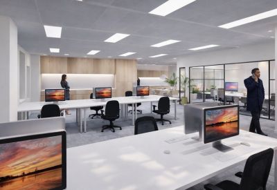 Open-plan workspace with multiple desks and large monitors.