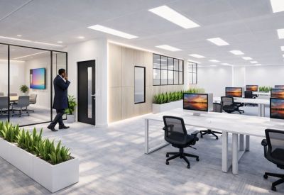 Spacious office area with white desks and greenery accents.