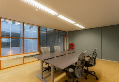 Meeting room with a long table and mesh office chairs.
