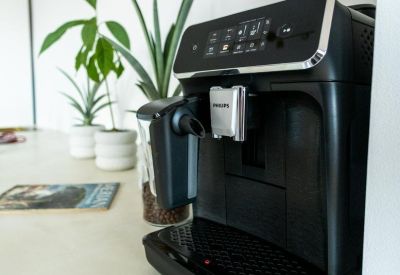 Minimalist reception area with a long counter and branded wall signage.