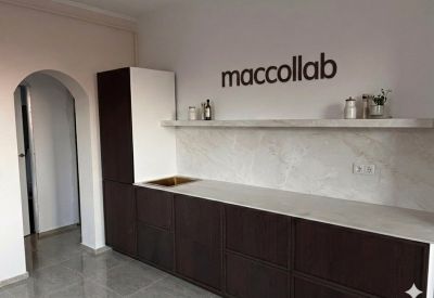 Attic office showing the intersection of glass walls and traditional timber beams.