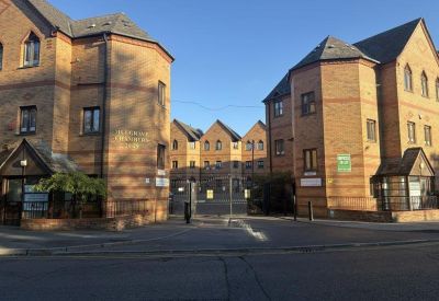 Exterior street view of the brick facade and gated entrance at 26-28 Mulgrave Road, Sutton, London.