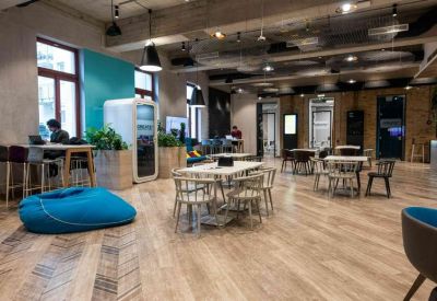 Café-style seating area with wooden floors and a blue bean bag.