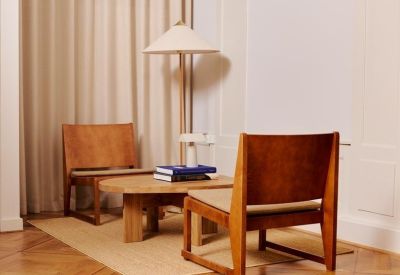 Lounge area featuring mid-century modern leather chairs and a low wooden coffee table.