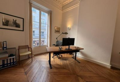Spacious office room with a sit-stand desk and classic architectural details.