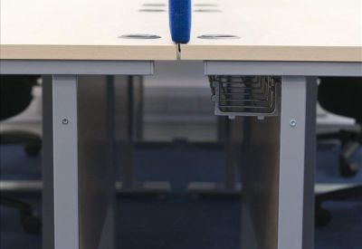 Detail of office desk legs and integrated cable management tray.