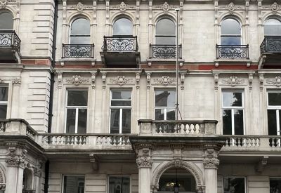 Classic stone facade and ornate entrance of 28-30, Grosvenor Gardens in London.