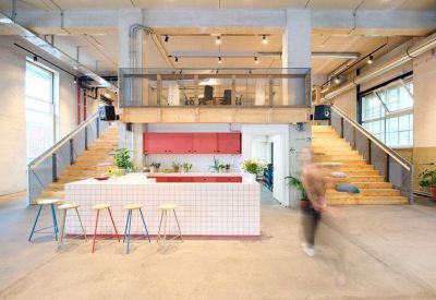 Open reception and lobby area featuring a tiled counter and double wooden staircases.