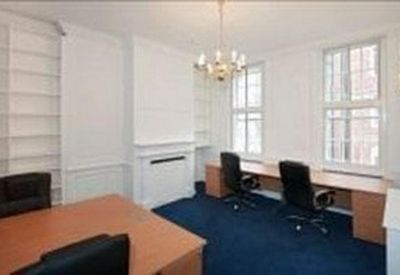 Spacious office suite with a chandelier, period features, and multiple workstations.