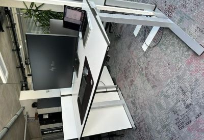 Overhead view of a white office desk system with integrated power and data ports.
