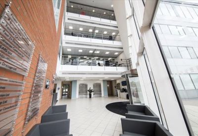 Bright multi-story atrium with polished floors and glass balconies.