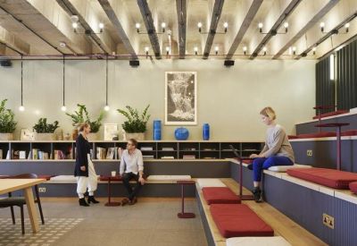 Sunken lounge area with tiered seating, red cushions, and hanging globe lights.