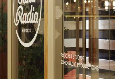 Glass door entrance featuring the Soho Radio Studios logo and podcast studio signage.