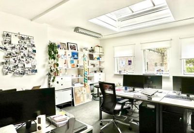 Creative open-plan office with a large skylight and inspiration wall.