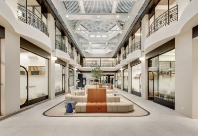 Grand multi-level indoor atrium with central seating and symmetrical balconies.