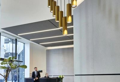 Lobby at 34 Lime Street featuring a black reception desk and unique gold pendant lighting.