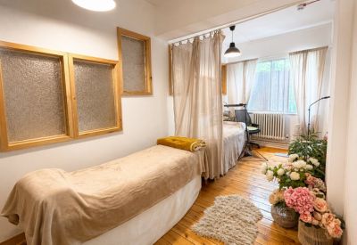 Therapy or massage room with two treatment beds and soft lighting.