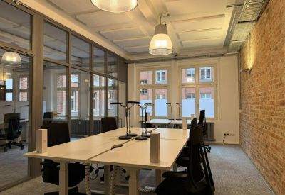 Internal four-person office with brick walls and modern lighting.