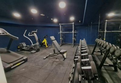 Fitness area with exercise equipment and mirrors.
