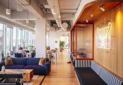 Reception hallway with built-in seating, wooden wall paneling, and a neon graphic.