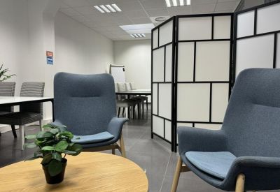 Seating area with comfortable chairs and a small table.
