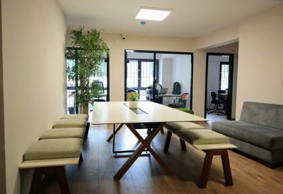 Communal dining or workspace area with a large wooden table and bench seating.