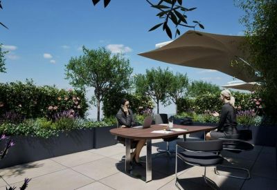 Outdoor terrace meeting area with umbrellas and greenery.