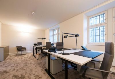 Private office with four desks and natural light.