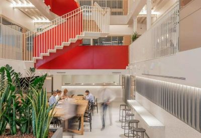 Breakout area with a red feature staircase and indoor plants.